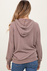 woman wearing a mauve ribbed maternity hoodie with a hood and long sleeves, showing the back view