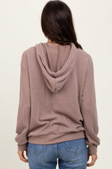 woman wearing a mauve ribbed hoodie with a relaxed fit and back view, paired with blue jeans