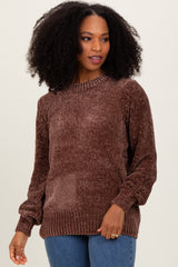 woman wearing a brown textured knit sweater with long sleeves and a round neckline