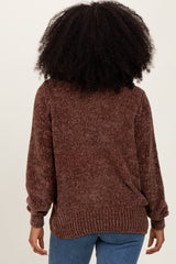 woman wearing a brown textured knit sweater with long sleeves and a relaxed fit