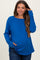 woman wearing a bright blue long sleeve maternity top with a relaxed fit and side pockets, showcasing her baby bump