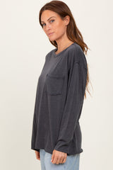 woman wearing a dark gray long sleeve top with a chest pocket and relaxed fit