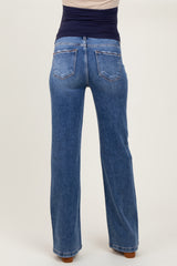 woman wearing light blue maternity jeans viewed from the back, featuring a wide leg style and a high waistband