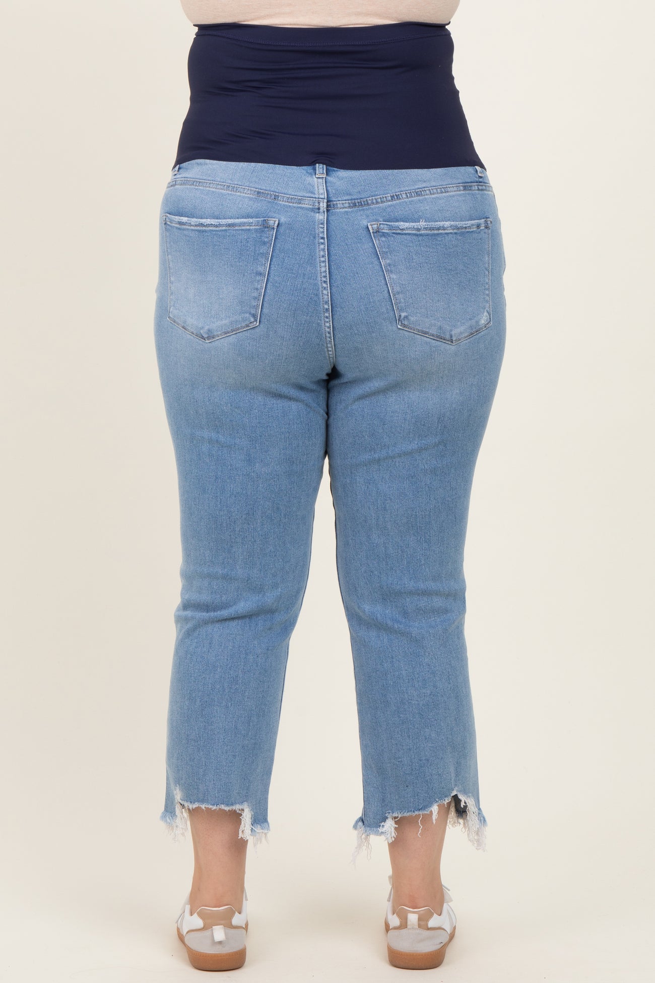 maternity plus light blue cropped jeans with frayed hem and stretchy navy waistband, worn by a model from the back