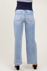 woman wearing light blue maternity jeans viewed from the back with a wide leg and a dark waistband