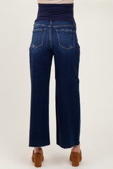 woman wearing dark blue maternity jeans with a high waistband and a relaxed fit, shown from the back