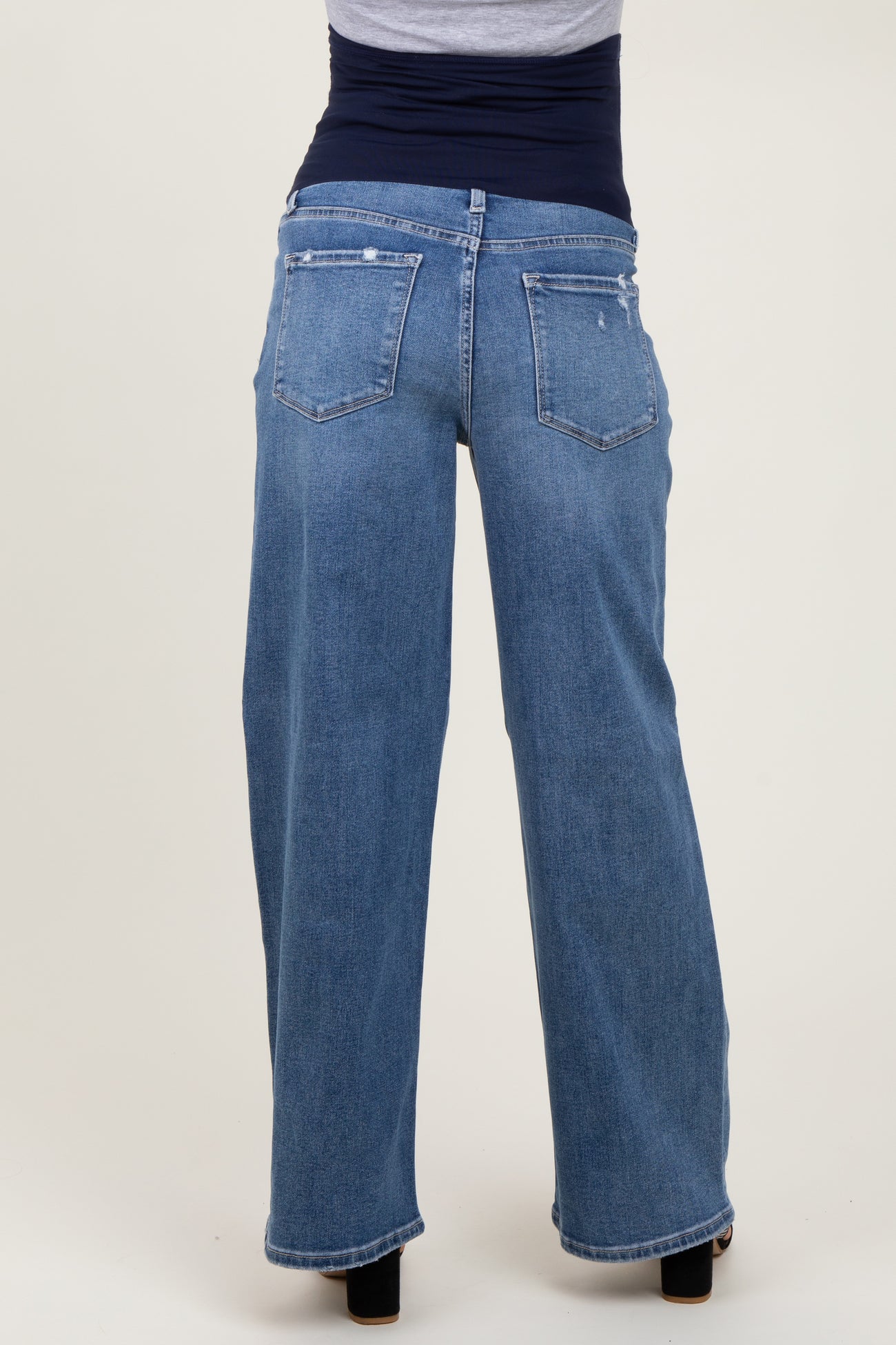 maternity wear light blue wide-leg jeans viewed from the back, featuring two back pockets and a relaxed fit