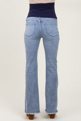woman wearing light wash maternity jeans with a frayed hem and a stretchy waistband, showing the back view