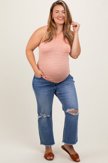 woman wearing a striped maternity tank top and distressed blue jeans, revealing her baby bump