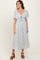 woman wearing a light blue floral maxi dress with a tie front and flutter sleeves