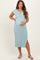 woman wearing a light teal ribbed maternity dress with buttons and a side slit, showing her baby bump