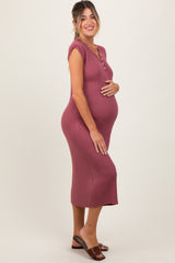 woman wearing a mauve ribbed midi maternity dress with short sleeves and buttons, showcasing her baby bump