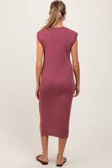 woman wearing a mauve ribbed maternity dress with cap sleeves and side slits, showing her back and hair down
