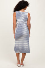 woman wearing a navy and white striped sleeveless midi dress, seen from the back