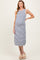 woman wearing a striped maternity dress with a fitted silhouette and side slits, showcasing her baby bump
