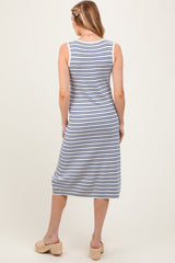 woman wearing a striped maternity sleeveless maxi dress standing with her back to the camera