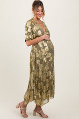 woman wearing a green floral print maternity maxi dress with a low neckline and a visible baby bump