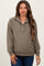 woman wearing a textured olive green maternity pullover with a collar and long sleeves, styled with blue jeans