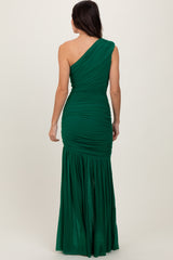 woman wearing a green one-shoulder ruched gown with a flowing bottom, view of the back