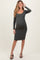 woman wearing a dark gray long sleeve maternity dress with a fitted silhouette and visible baby bump
