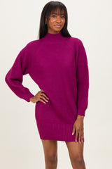 woman wearing a fuchsia ribbed sweater dress with long sleeves and a high neckline