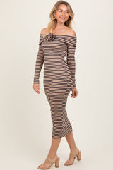 woman wearing a brown and beige striped off-the-shoulder midi dress with a flower detail at the neckline