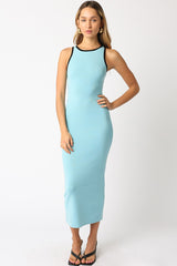 woman wearing a light blue sleeveless maxi dress with black trim and heels