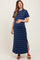 woman wearing a navy striped maternity maxi dress with a side slit and holding her baby bump