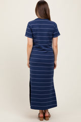 woman wearing a navy striped maternity maxi dress with short sleeves and side slits, showing a baby bump