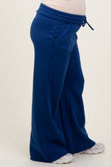 maternity wear in blue wide-leg sweatpants with a drawstring waist and side pockets, featuring a visible baby bump