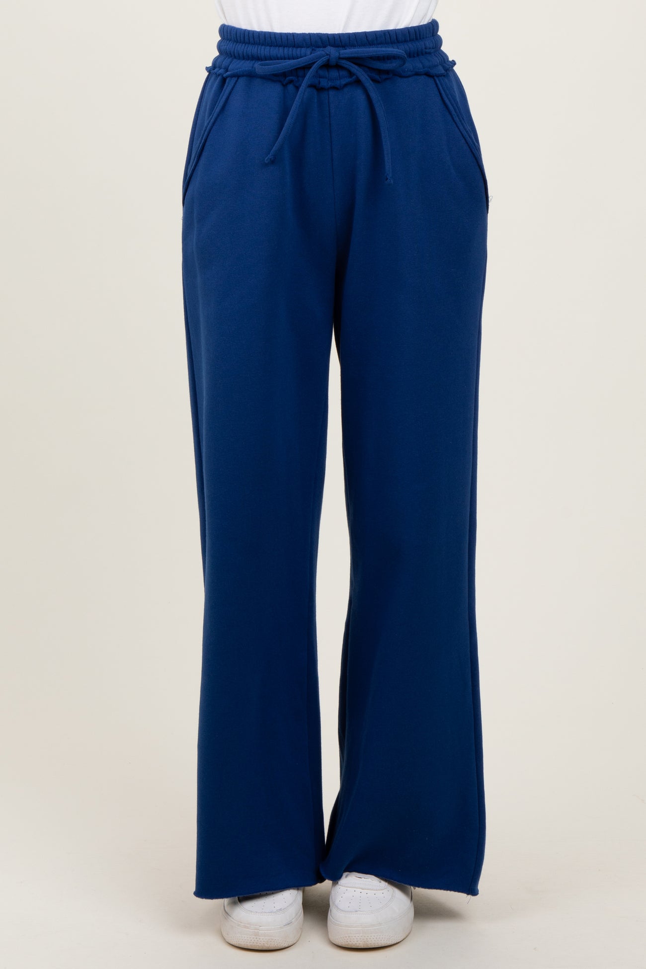 woman wearing blue wide-leg lounge pants with an elastic waistband and side pockets