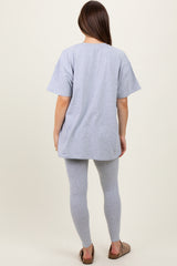 woman wearing a light gray oversized maternity t-shirt and matching leggings, showing a relaxed fit from the back