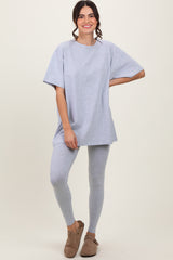 woman wearing a gray oversized t-shirt and matching leggings, styled with casual slip-on shoes