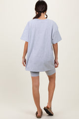 woman wearing a gray oversized t-shirt and coordinating gray biker shorts, viewed from the back