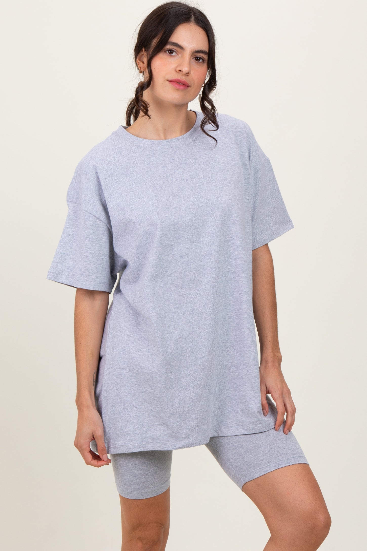 woman wearing a gray oversized t-shirt and matching gray bike shorts