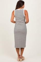 woman wearing a black and white striped maternity dress with a form-fitting design and knee-length cut