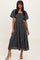 woman wearing a dark gray floral midi dress with puff sleeves and a smocked bodice