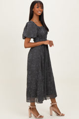 woman wearing a dark gray floral printed midi dress with puff sleeves and a smocked waist, paired with light pink heels