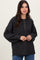 woman wearing a dark gray oversized henley sweater with buttons and balloon sleeves