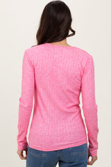 woman wearing a bright pink long sleeve ribbed top, view from the back with a casual fit and a scoop neckline