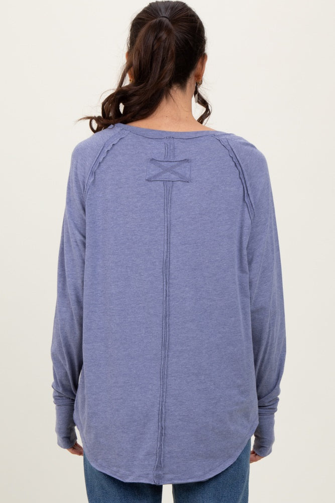 woman wearing a purple long sleeve top with a decorative back seam and relaxed fit