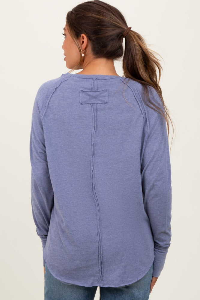 woman wearing a purple maternity long sleeve top with a relaxed fit and back seam detail