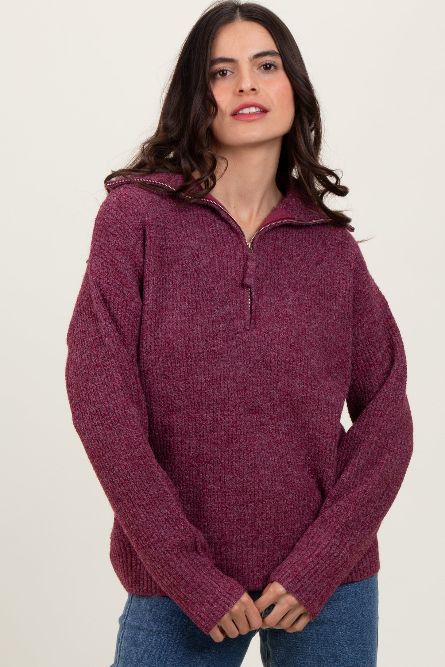 woman wearing a burgundy zip-up sweater with a relaxed fit and ribbed detailing
