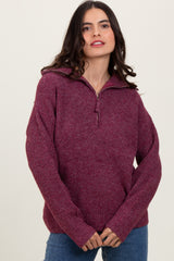 woman wearing a burgundy zip-up sweater with a relaxed fit and ribbed detailing