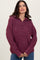 woman wearing a burgundy zip-up sweater with a relaxed fit and ribbed detailing