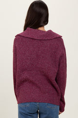 woman wearing a cozy, oversized plum sweater with a wide collar, view from the back, paired with blue jeans