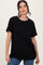 woman wearing a relaxed fit black t-shirt with short sleeves and a round neckline, paired with denim jeans