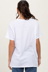 woman wearing a plain white oversized t-shirt, viewed from the back, paired with blue jeans