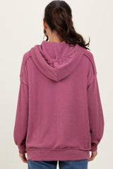 woman wearing a cozy mauve oversized hooded sweatshirt with ribbed texture viewed from the back