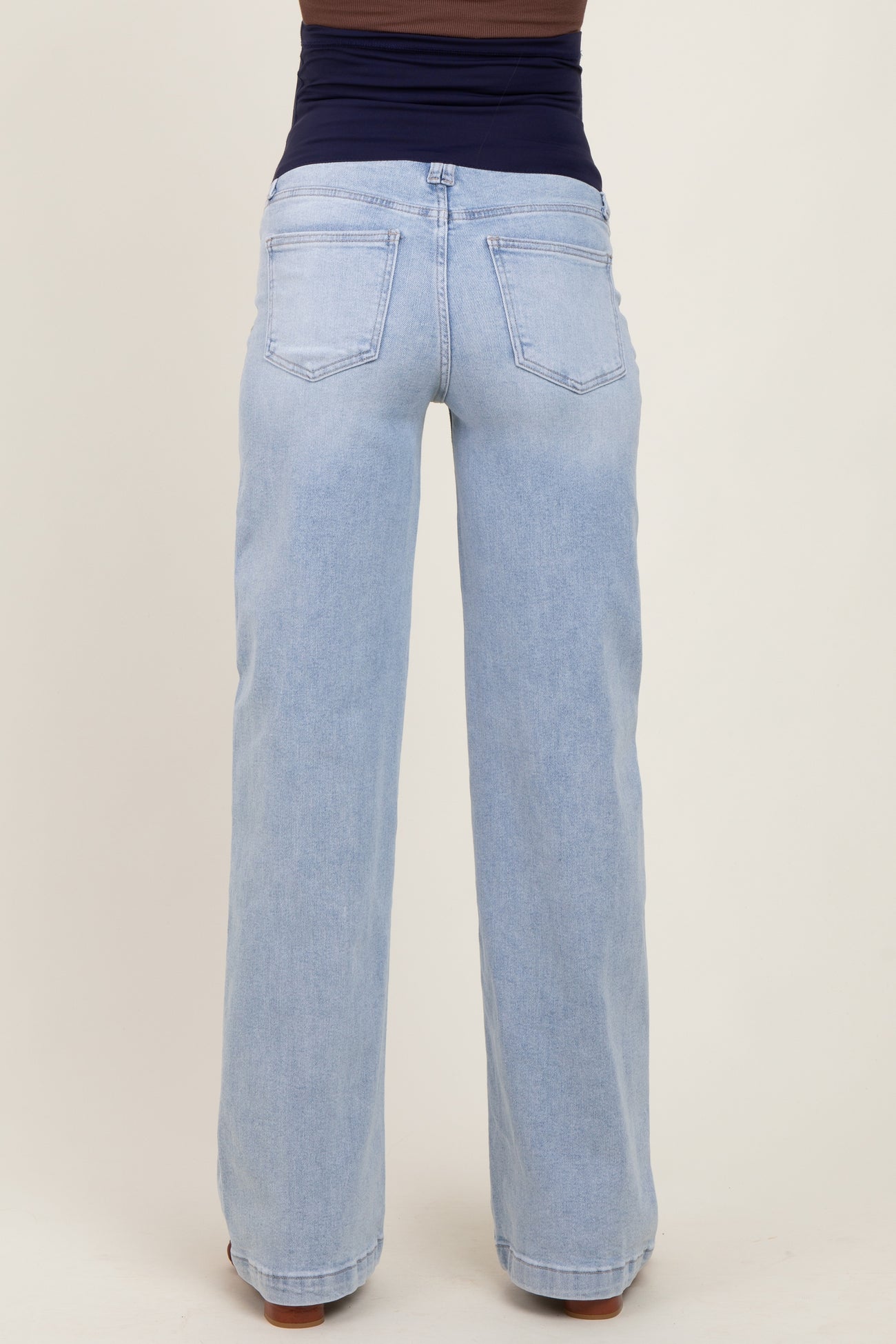 maternity wear light blue wide-leg jeans with a stretchy navy waistband